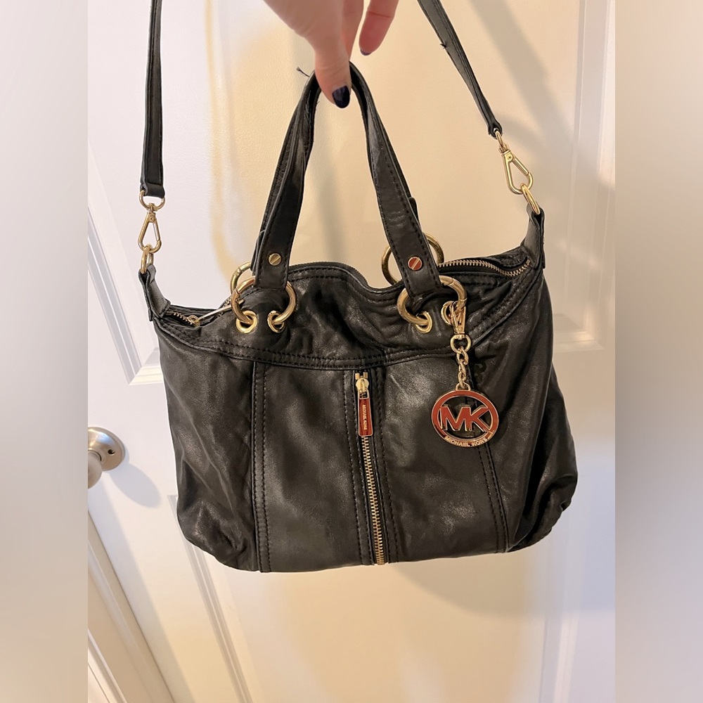 Michael Kors black and gold leather purse.